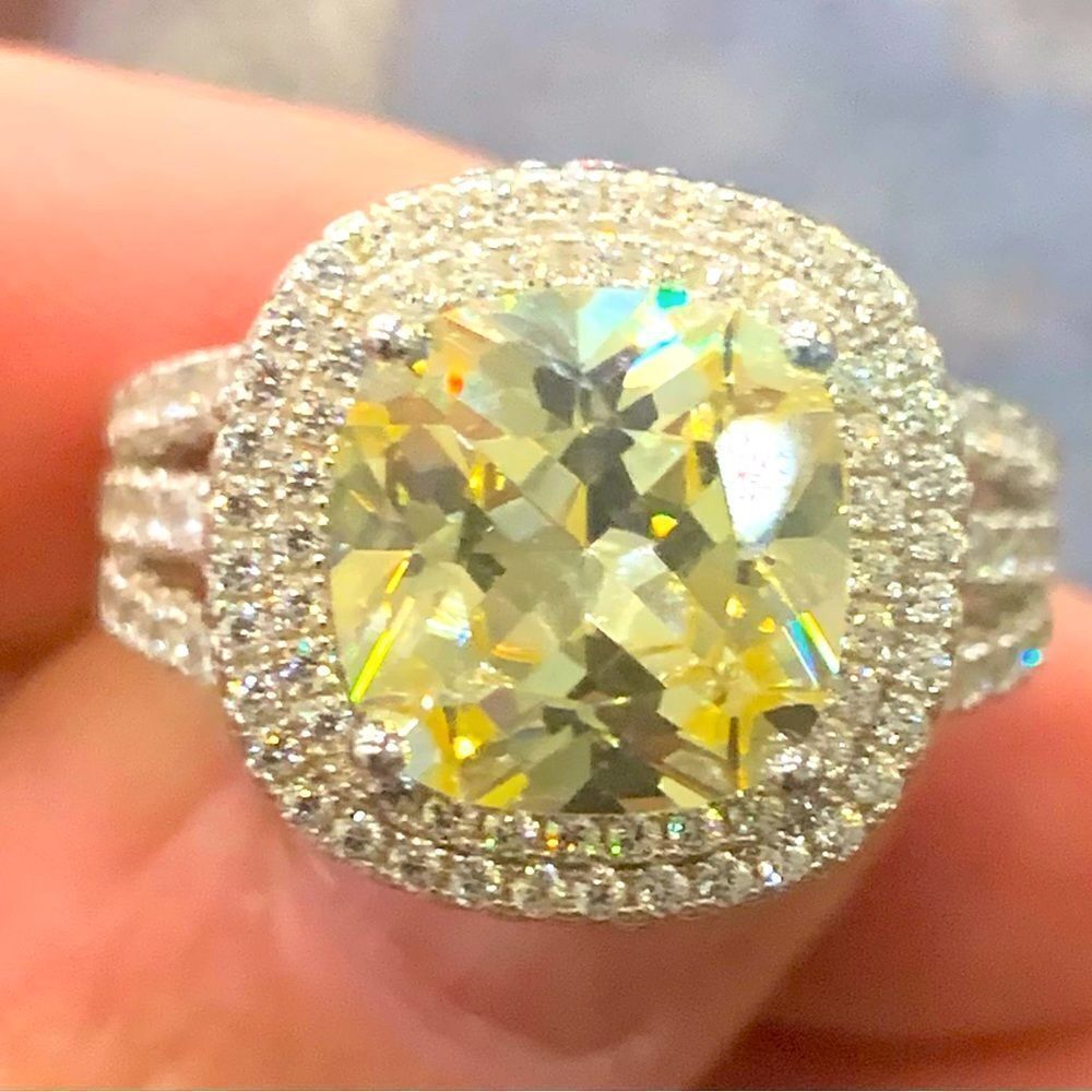 A beautifully set ring. Cushion cut canary Center-stone with pink stones around